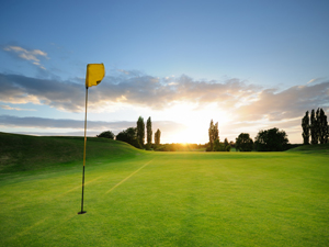golf course with flag and sunlight